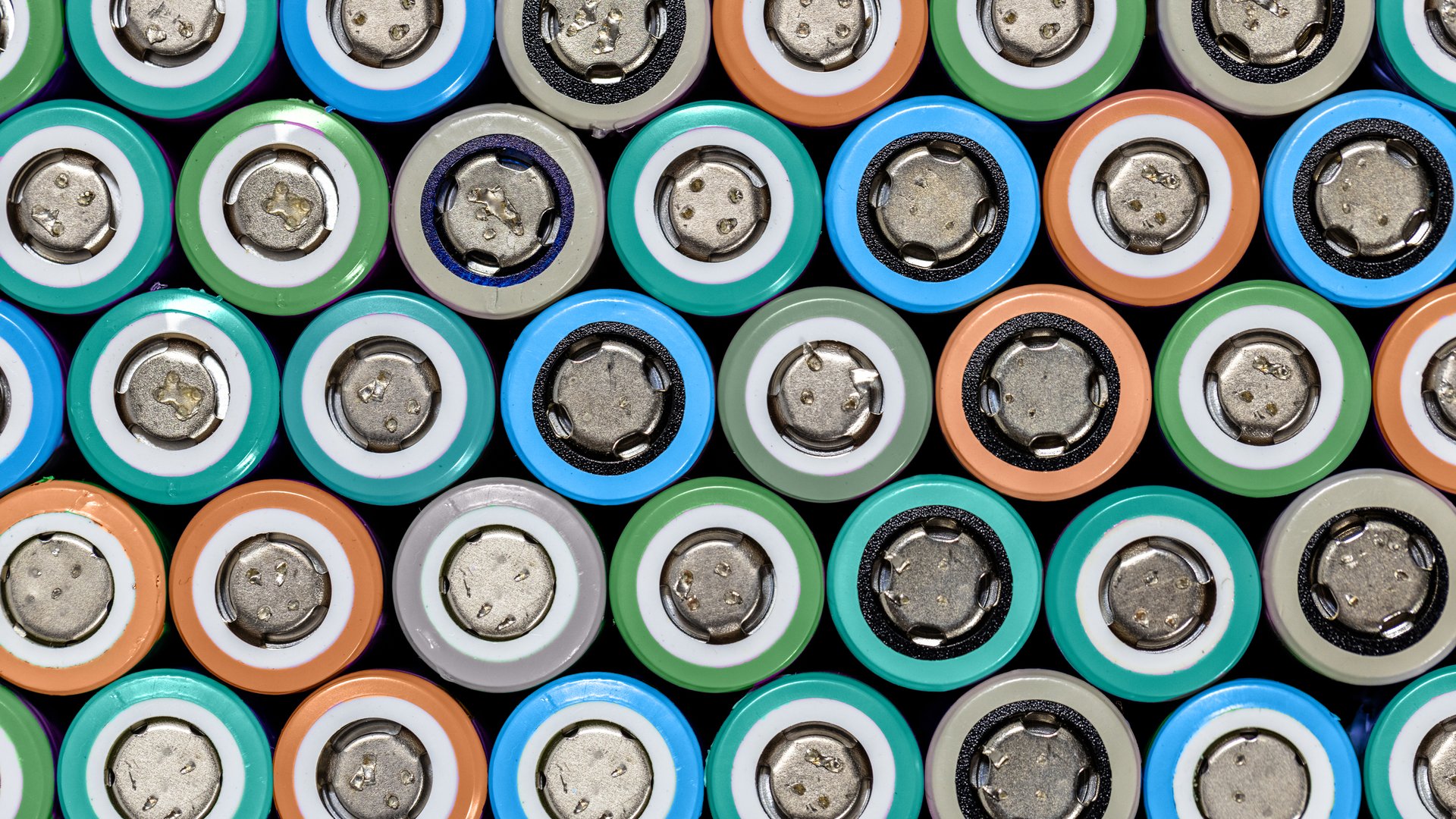 Close-up of cylindrical battery cells arranged in a grid with colored rings - Redwood Materials