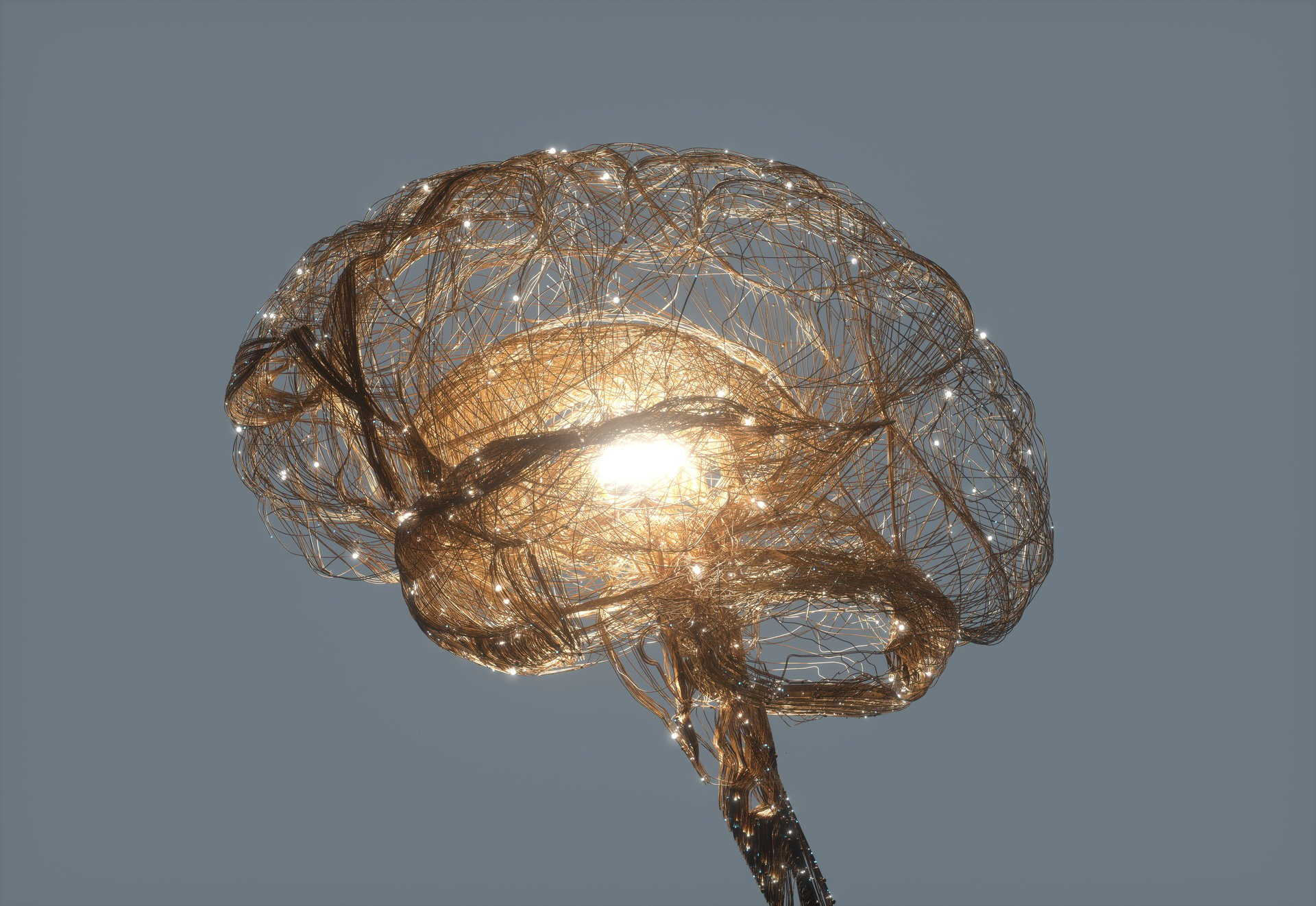 Computer generated render of nerves forming the structure of a brain with a bright light in the centre.