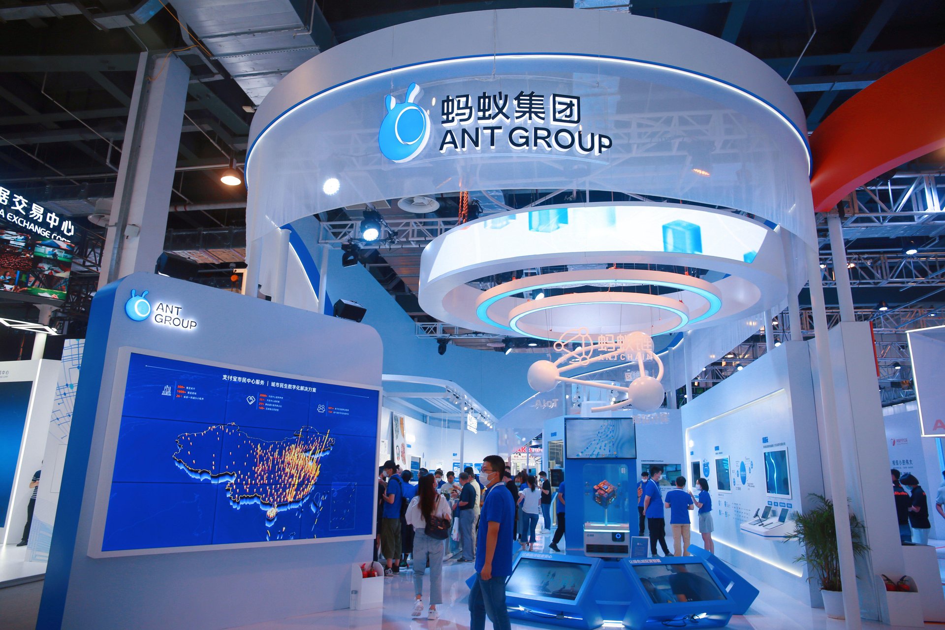 Ant Group booth with multiple displays inside a conference hall.