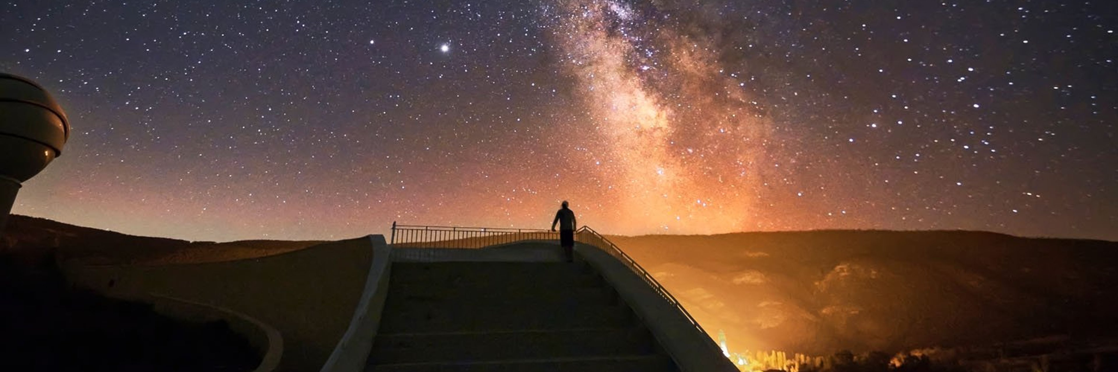 Person on grand staircase watching the Milky Way.