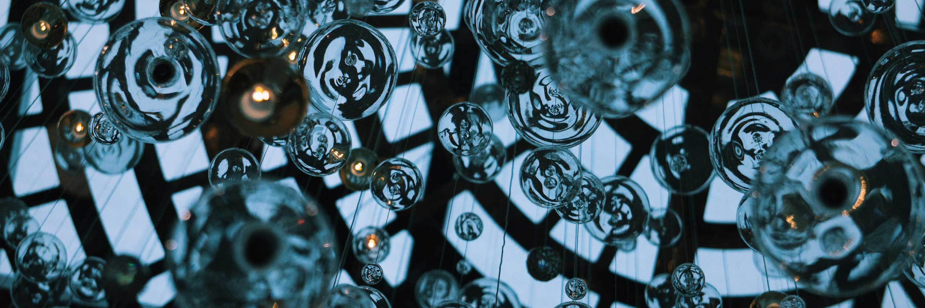 Close up of glass orbs forming a modern chandelier.