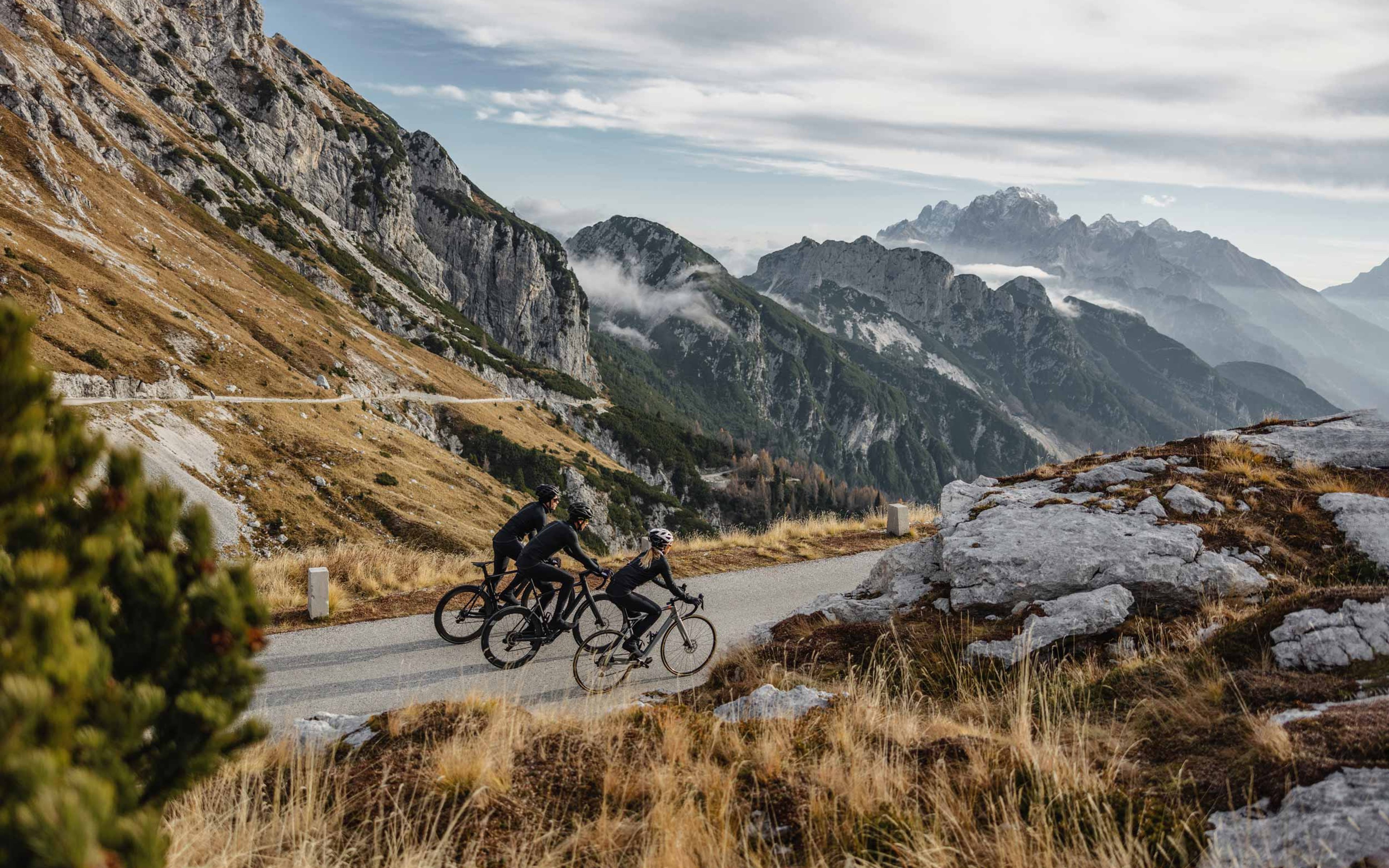 Three intrepid cyclists exploring scenic mountain trails on their high-performance bike.