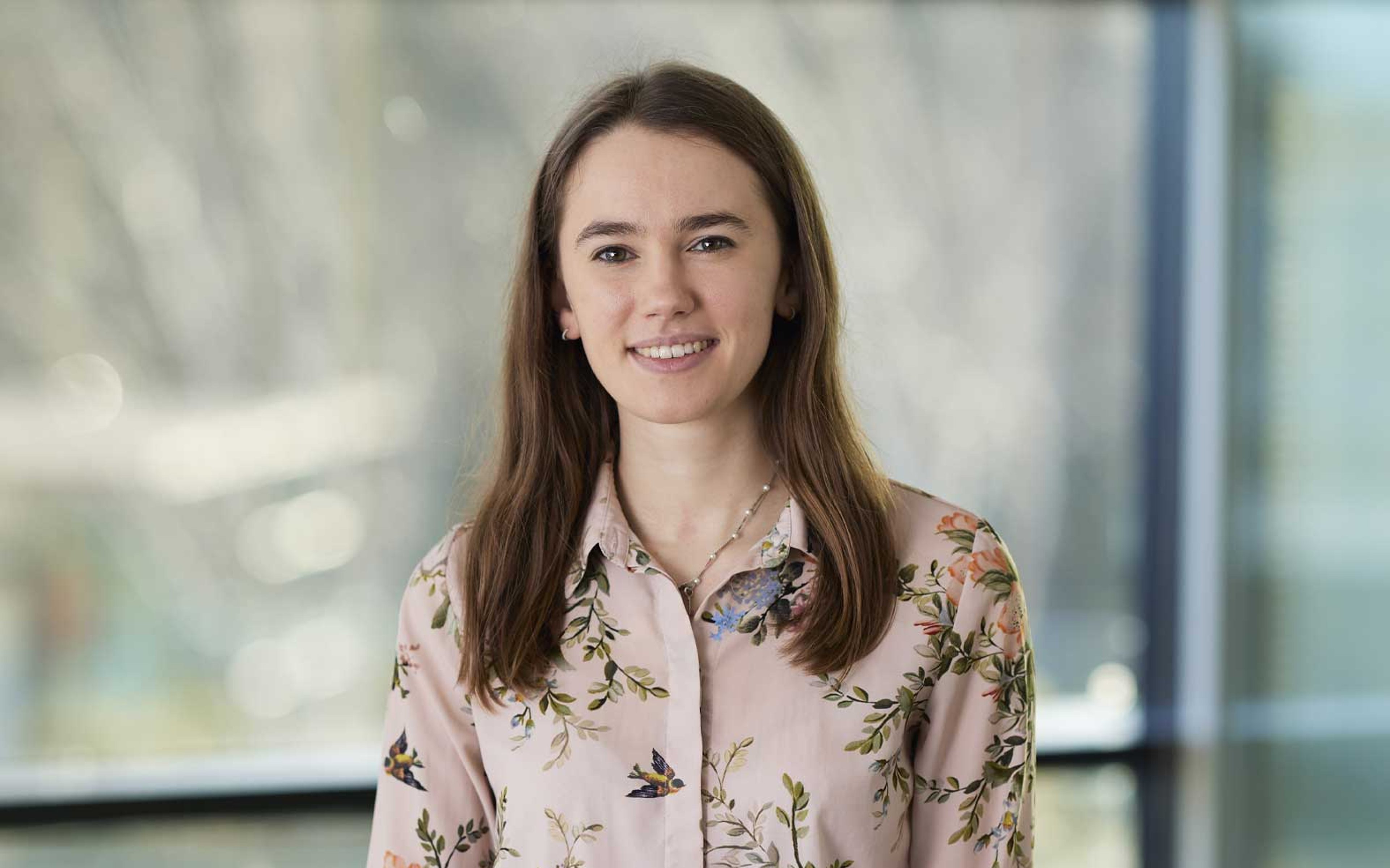 Sophia Sallis Tara standing while clutching a notepad.