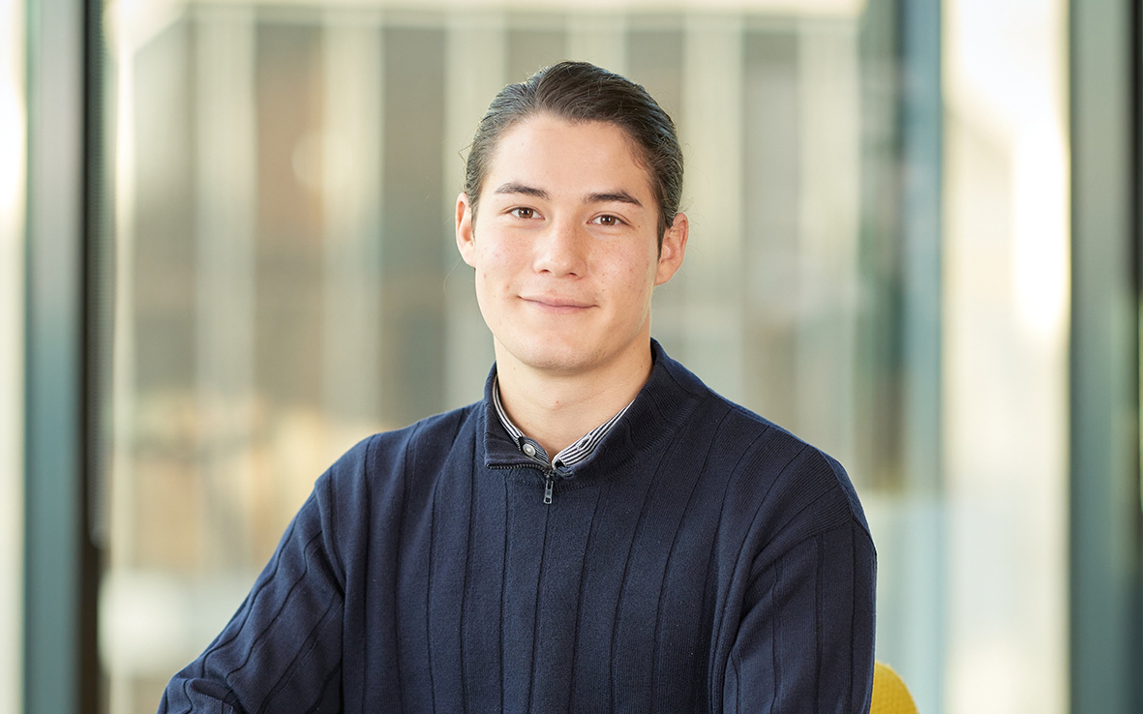 Kitsu Egerton sitting while leaning against a table.