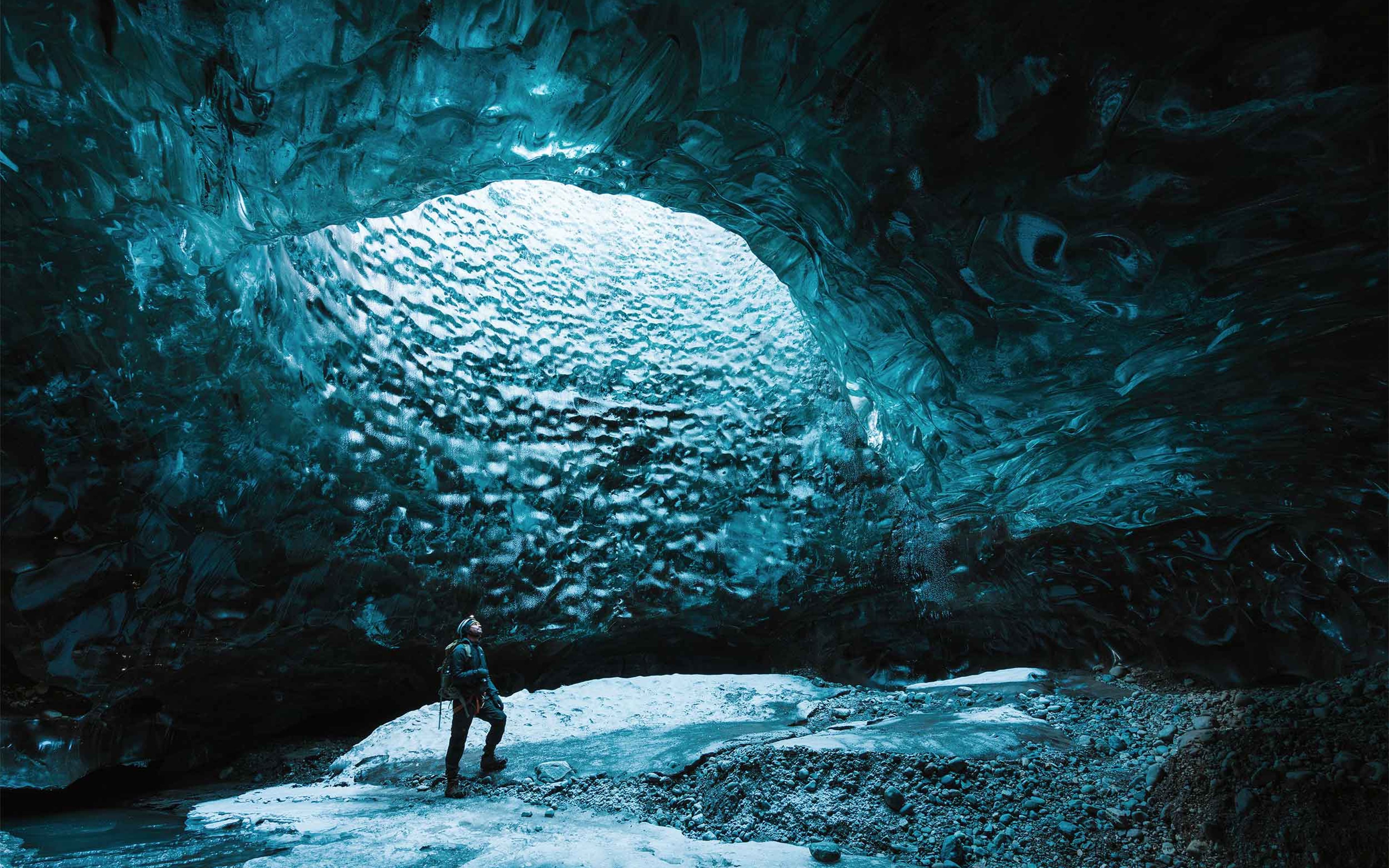 One man exploring beautiful Ice cave close to Jokulsarlon Glacier Lagoon.