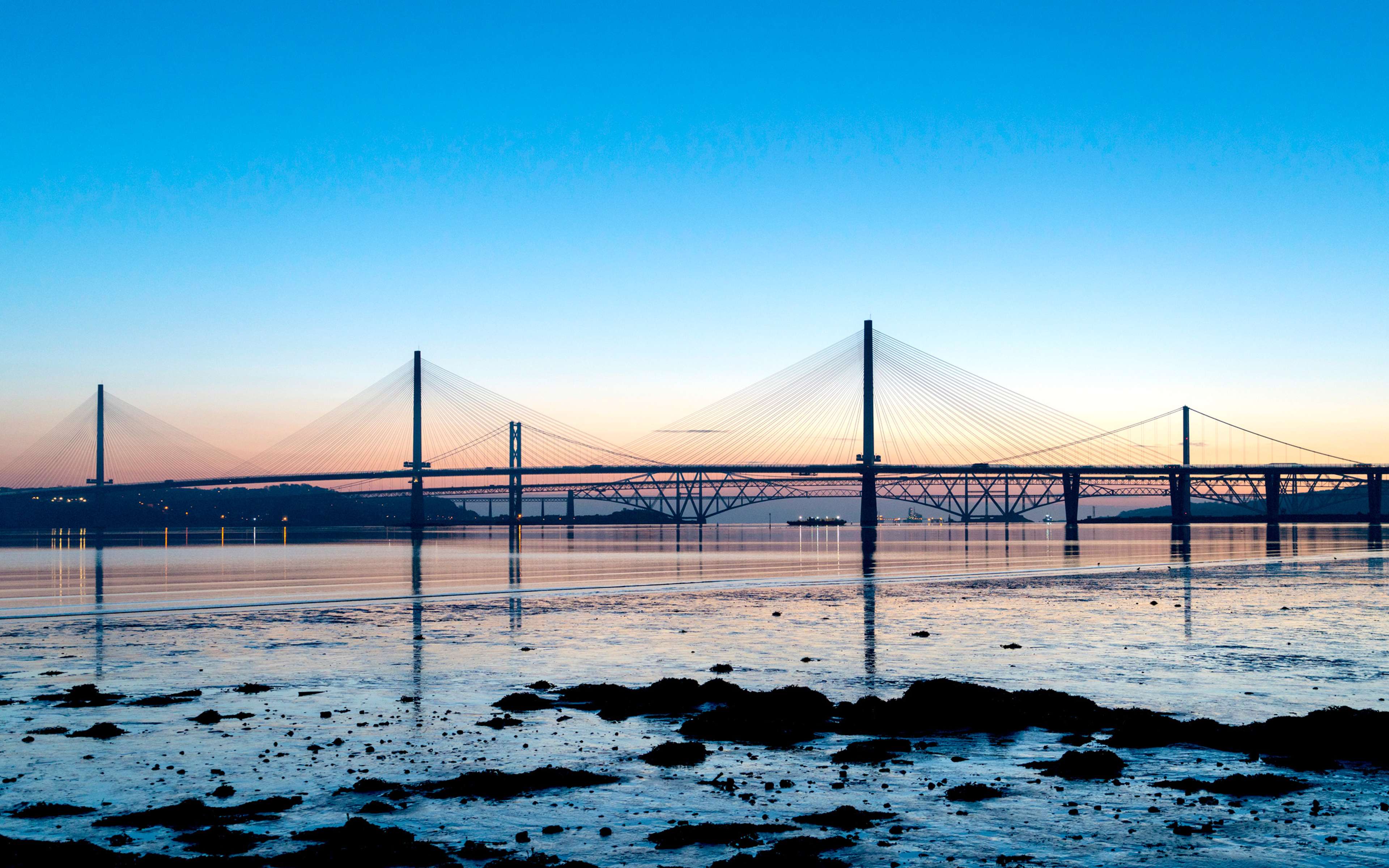 Sunrise view of the three major bridges crossing the Firth of Forth at South Queensferry.