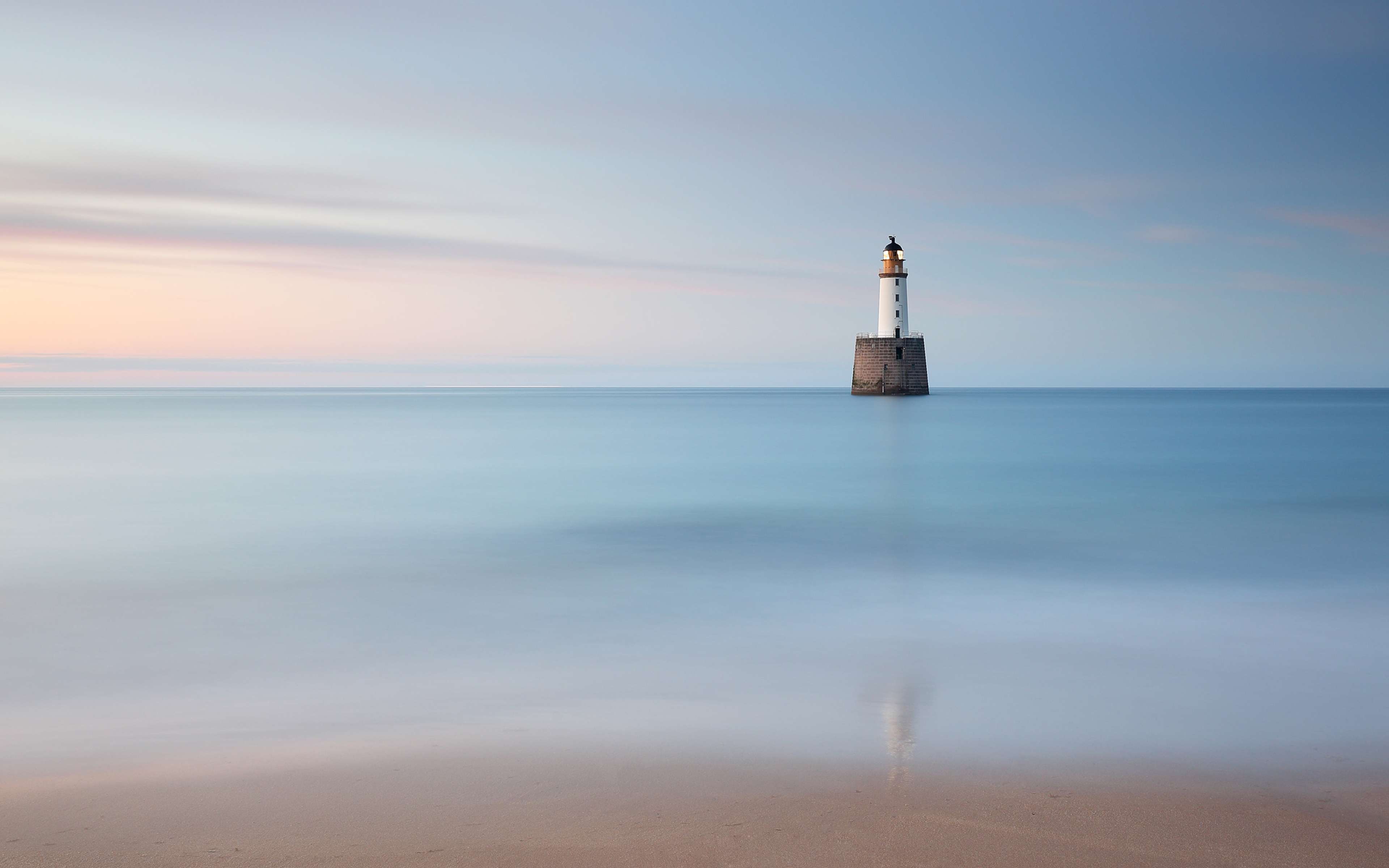 Rattray Head beach and lighthouse in the North Sea at dusk, Scotland.