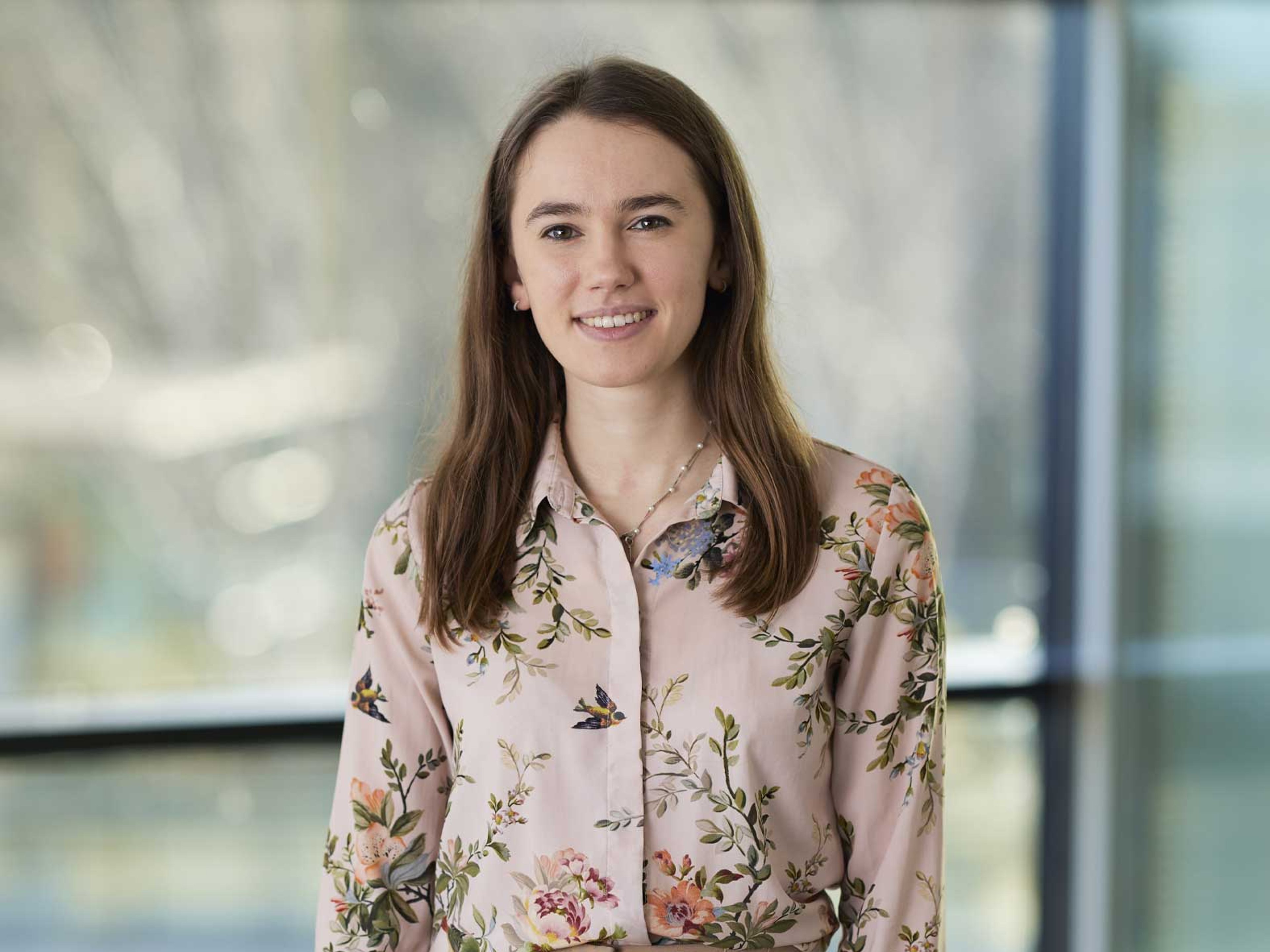 Sophia Sallis Tara standing while clutching a notepad.