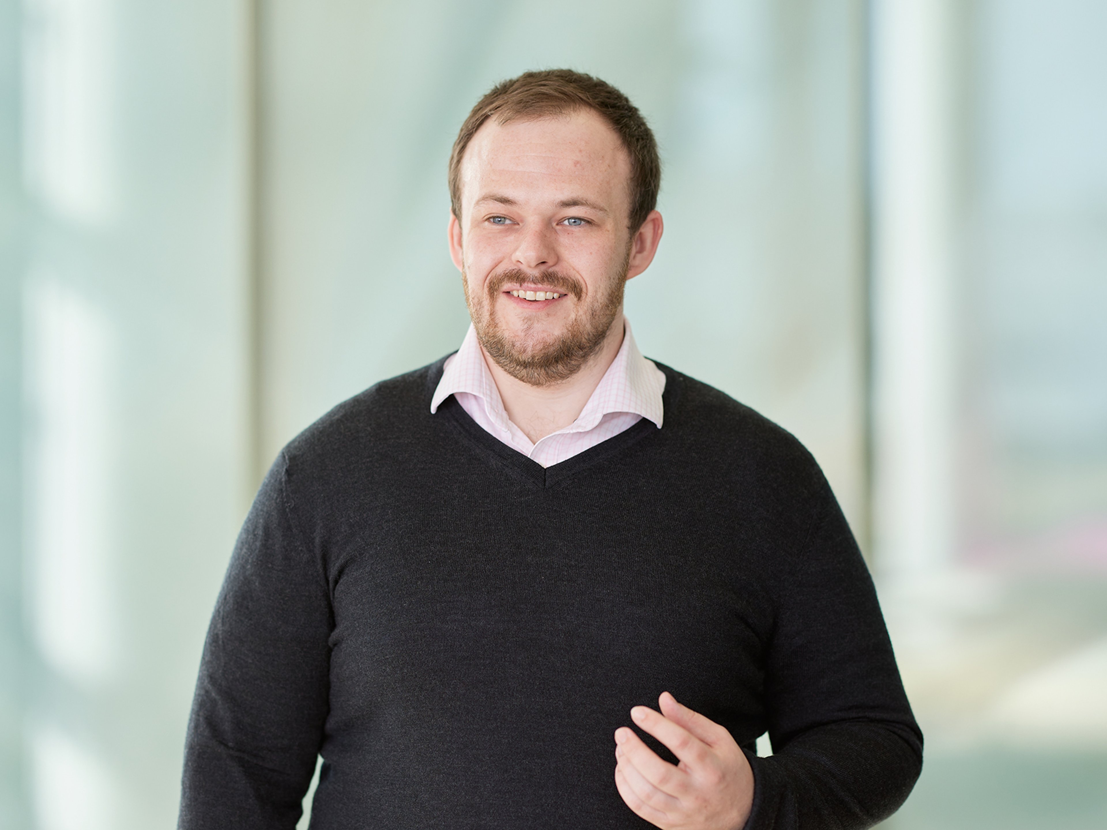 Michael O'Dwyer standing with a book under his arm.