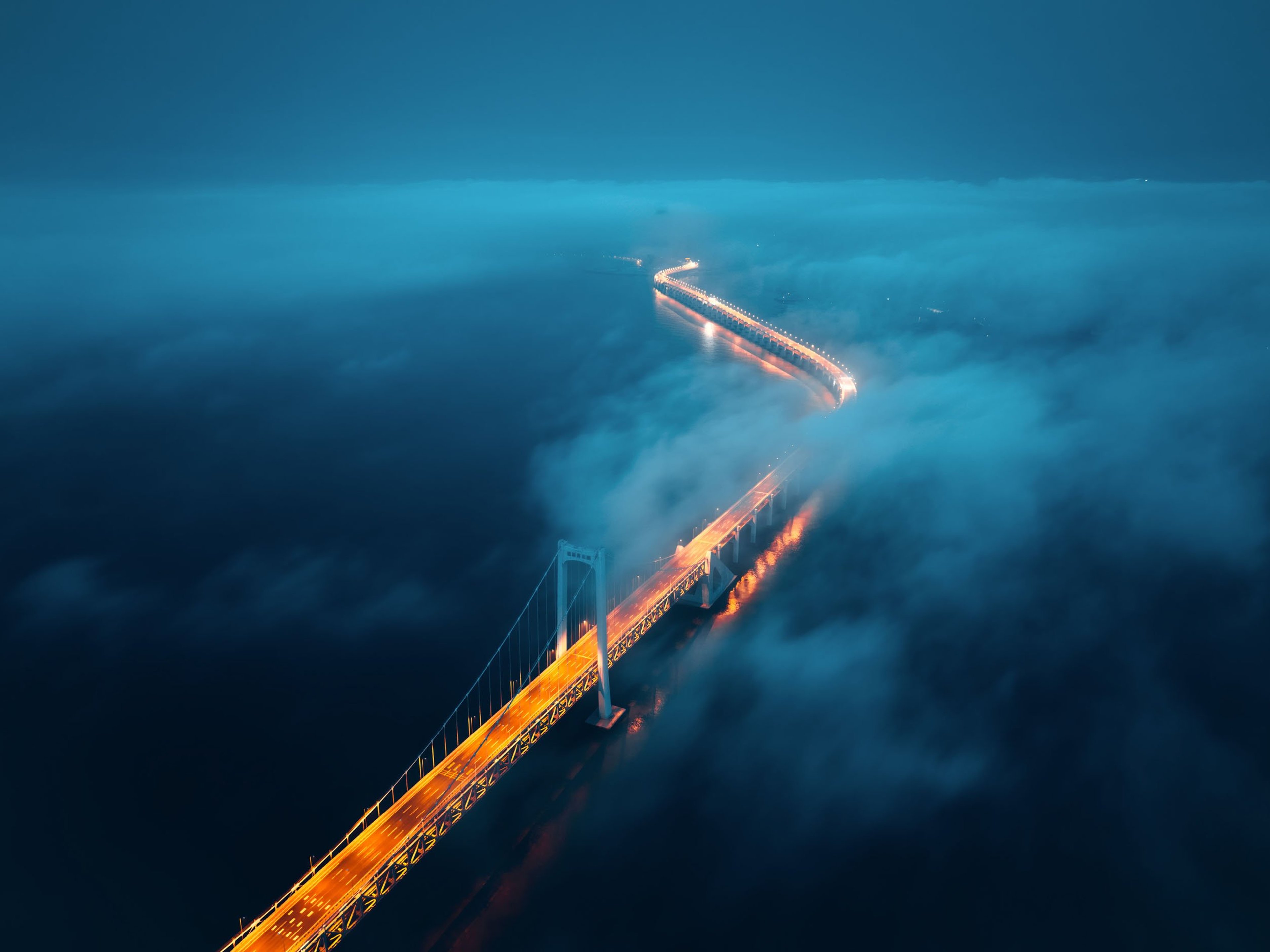 A cross-sea bridge in the fog at night in liaoning, China.