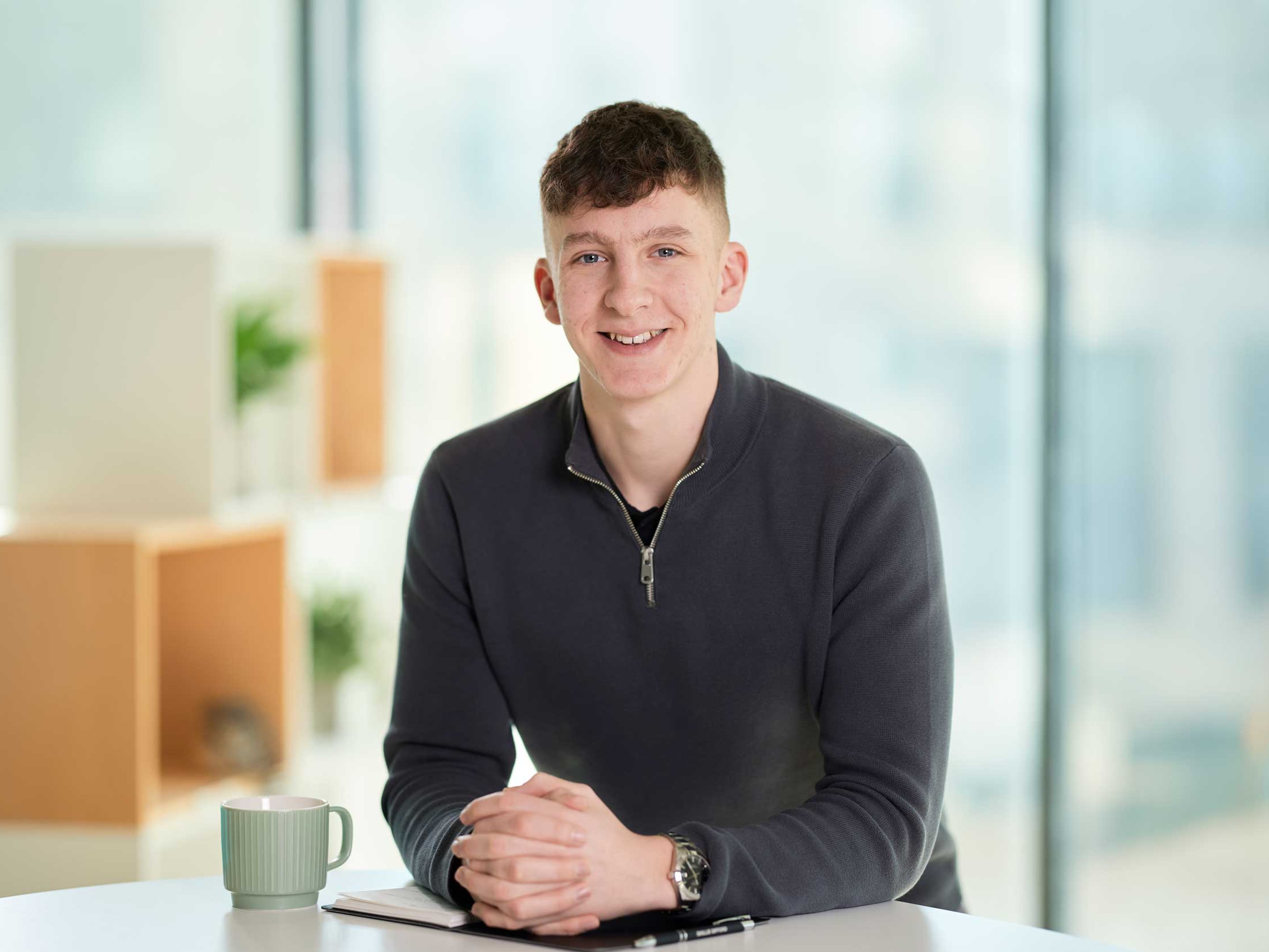 Adam Laidlaw stood leaning over a desk in the Baillie Gifford office.