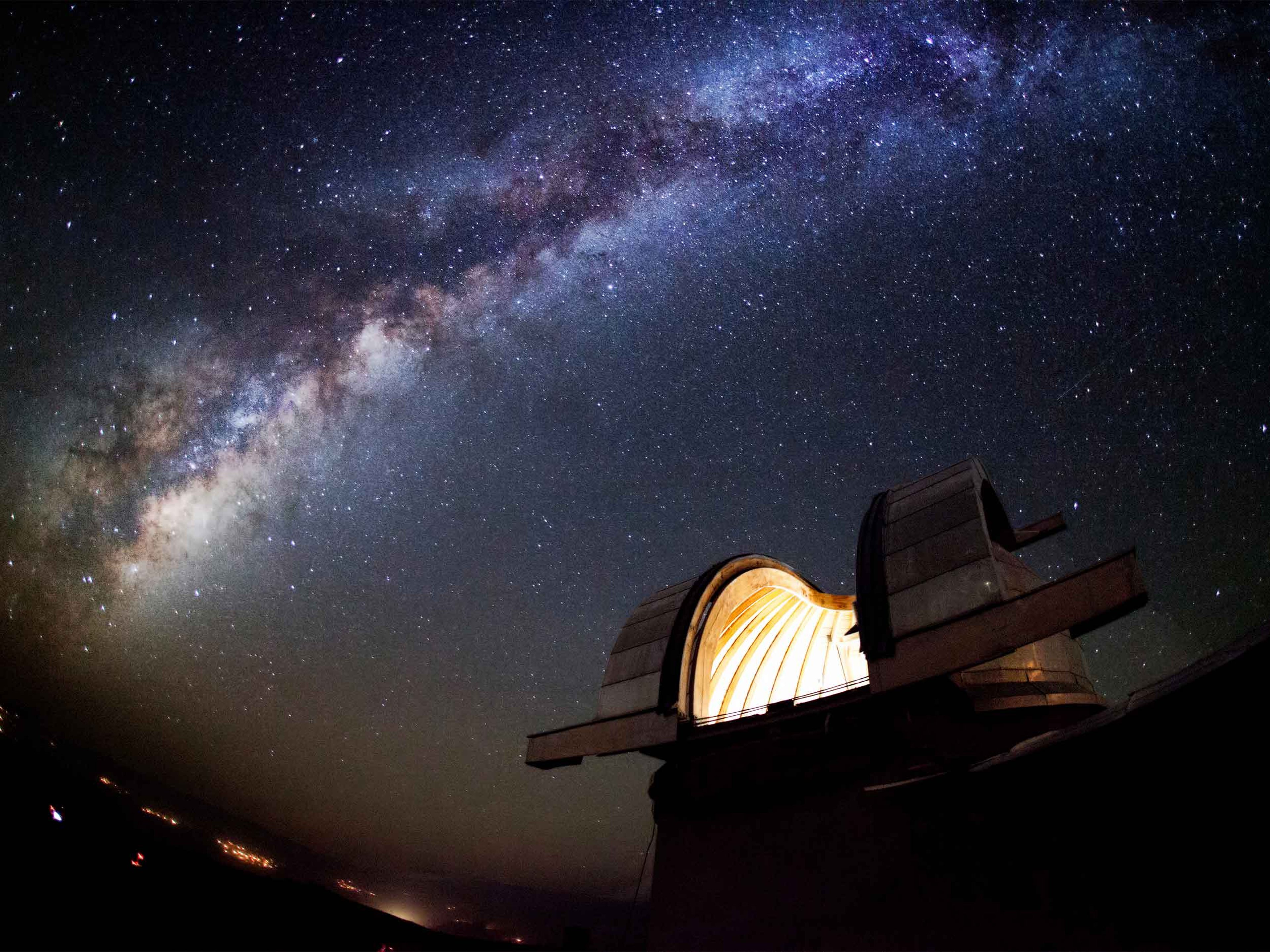 Astronomical Observatory under the starlit sky filled with the milky way.