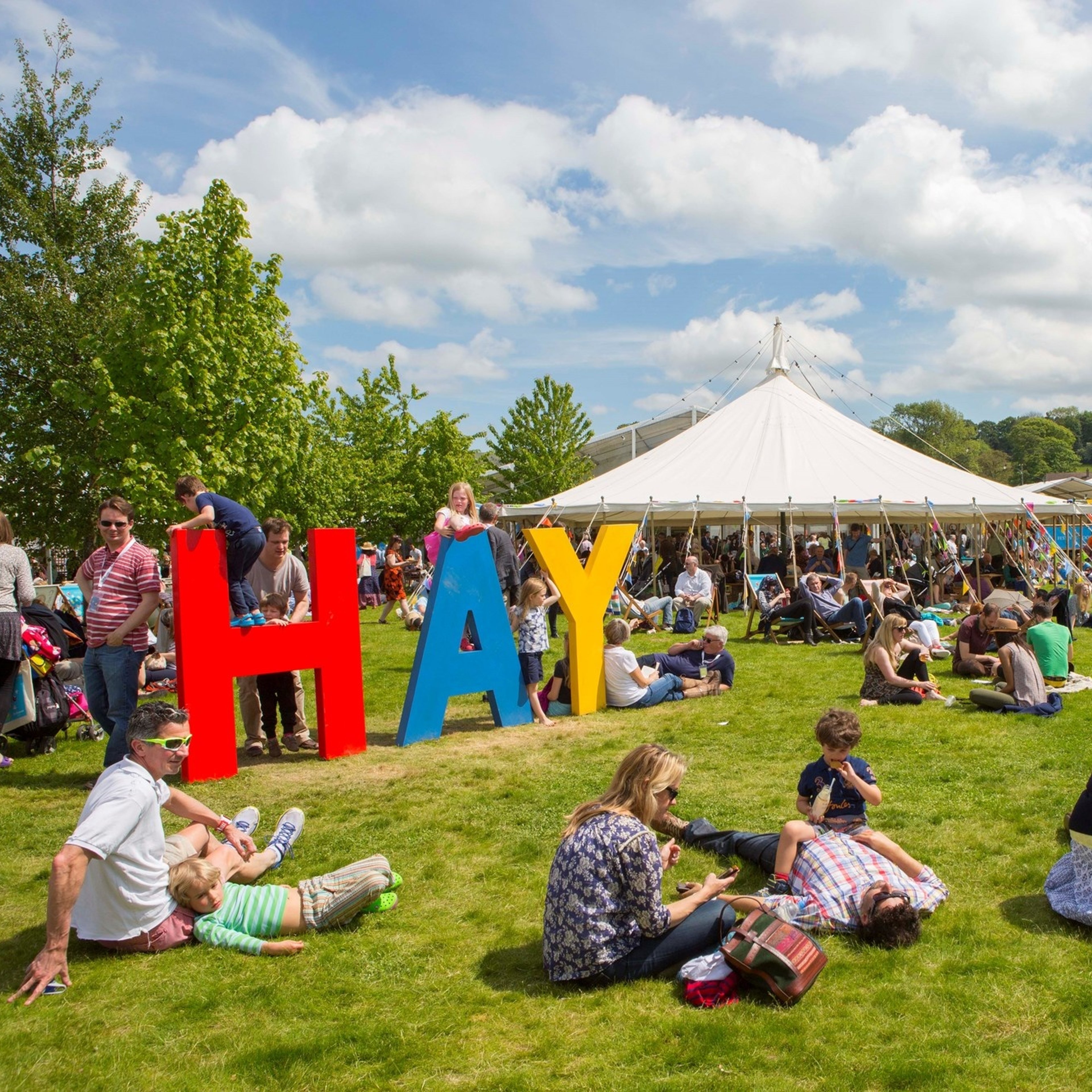 Hay Festival Tent with a bright sign saying Hay in capaital letters.