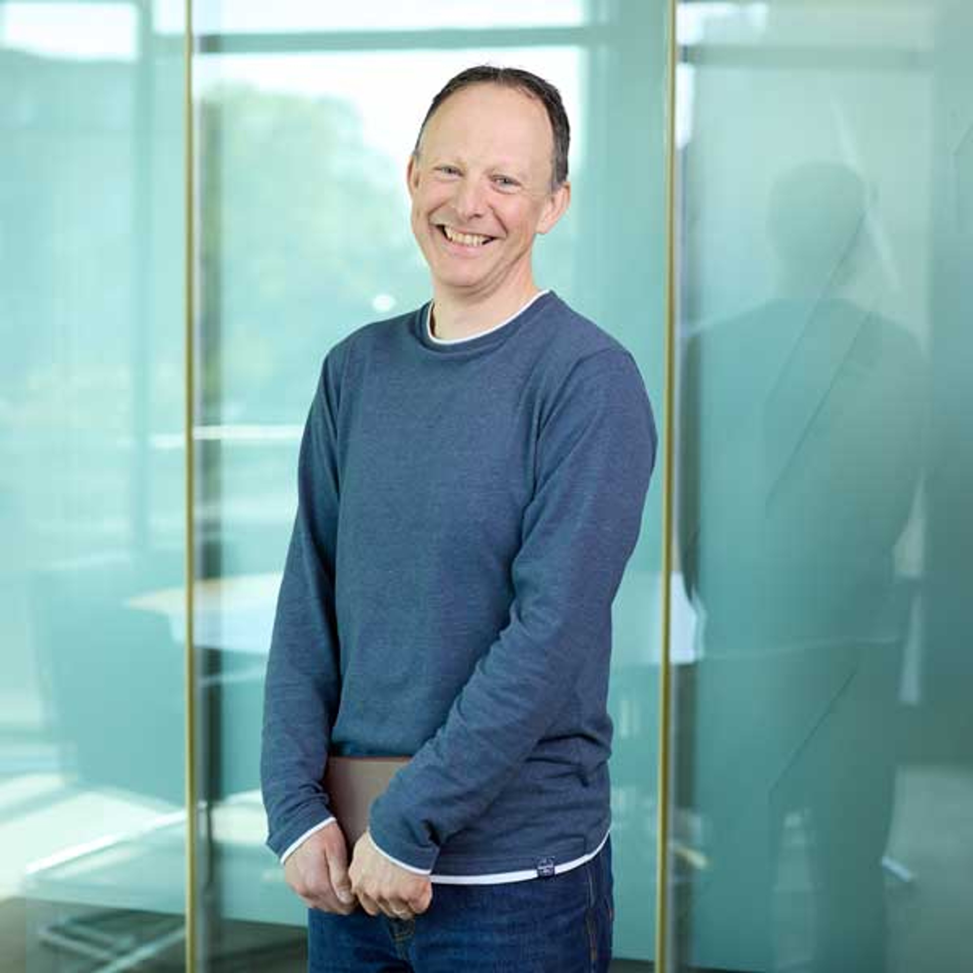 Matt Blackham standing while clutching a notepad.