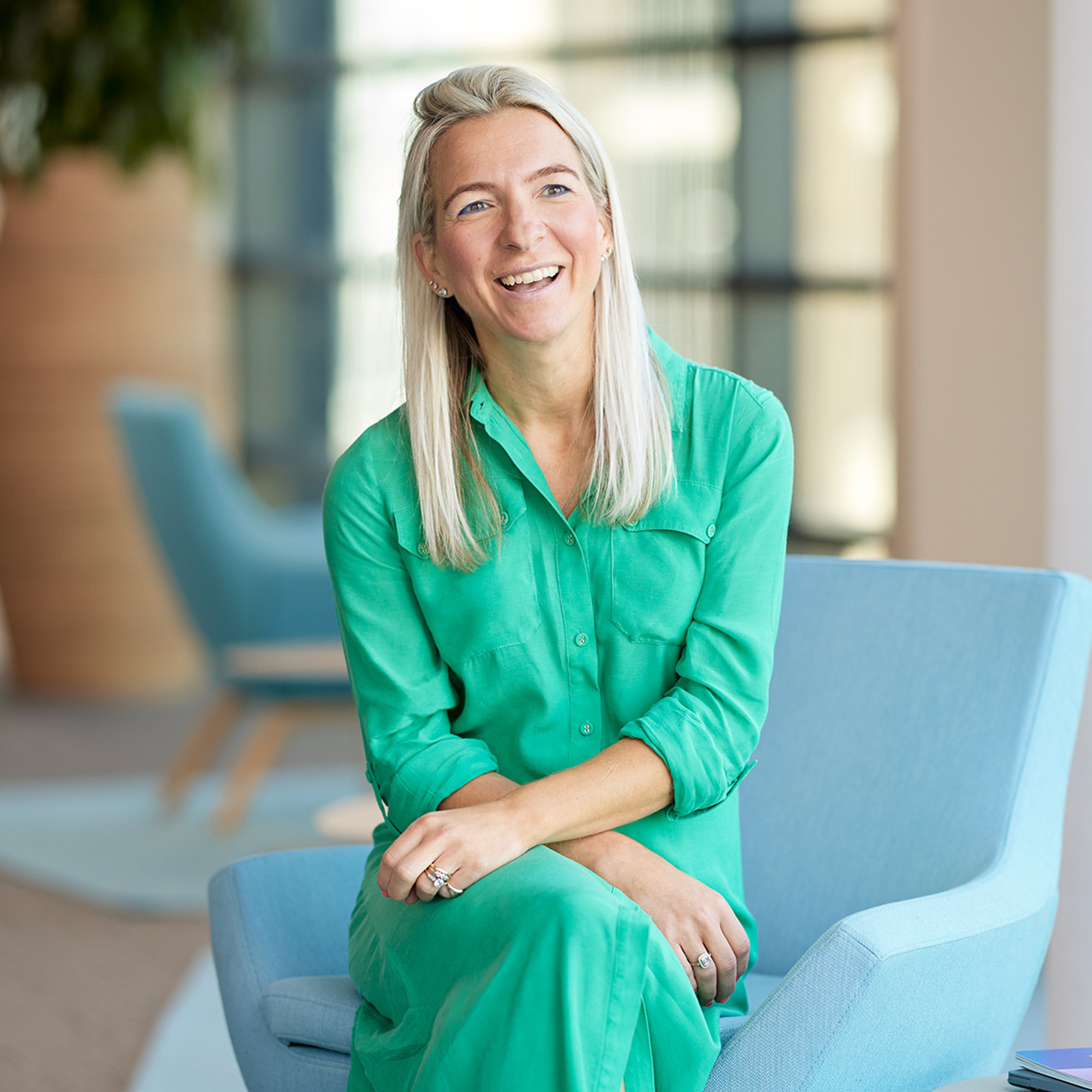 Kate Fox sitting with her arms on her lap.