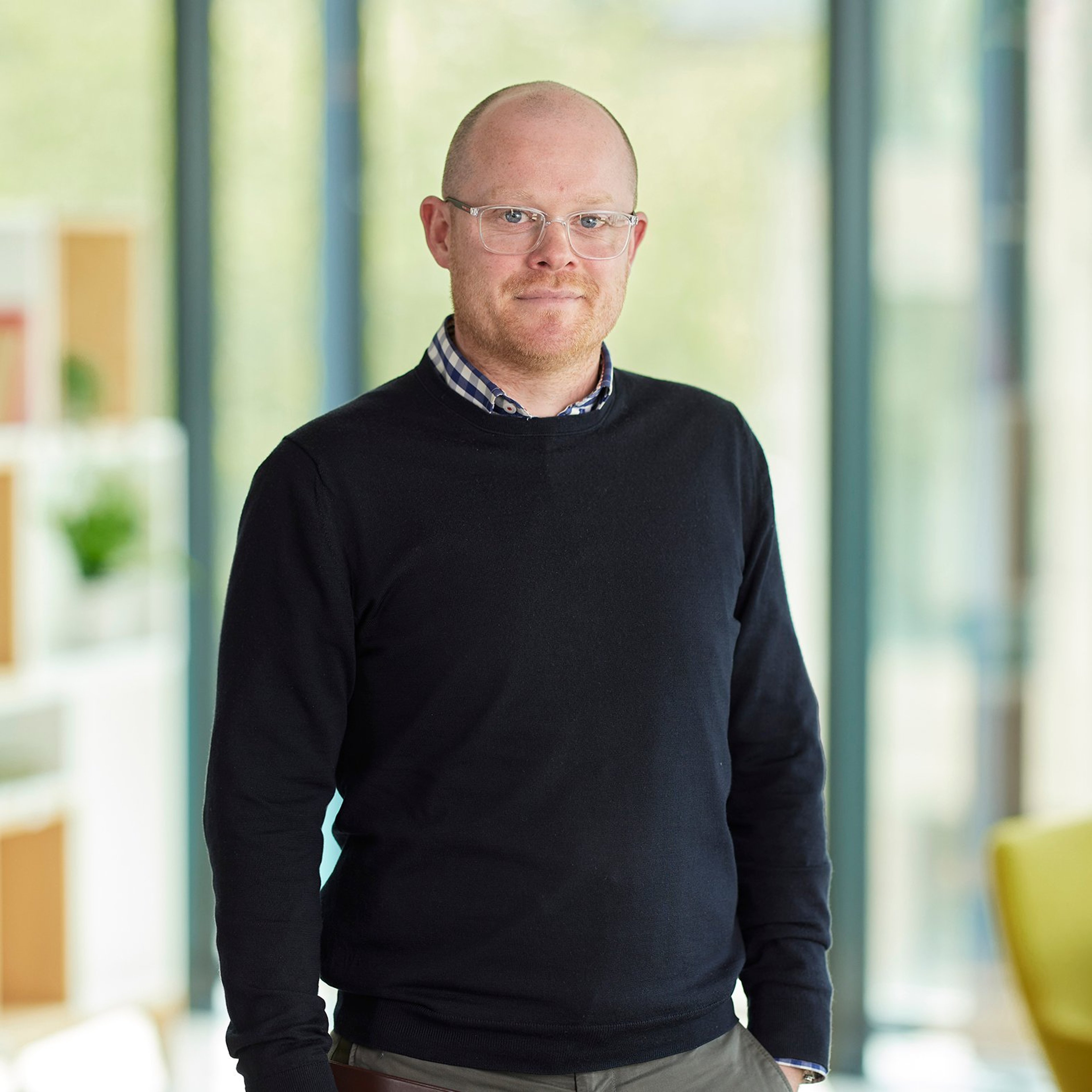 Kevin Mitchell standing in the Baillie Gifford office.