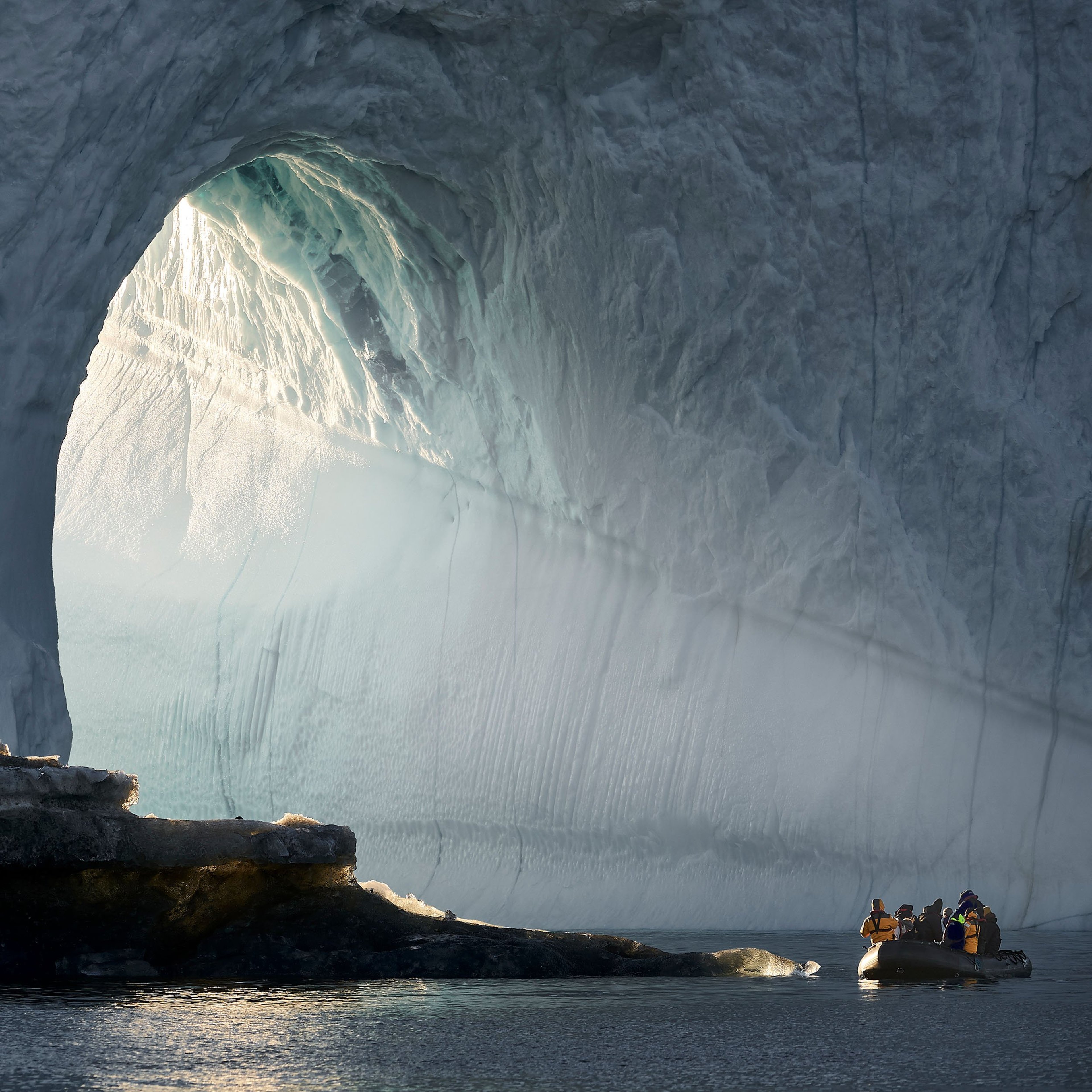 A rubber dinghy inside a large ice cave in Greenland.