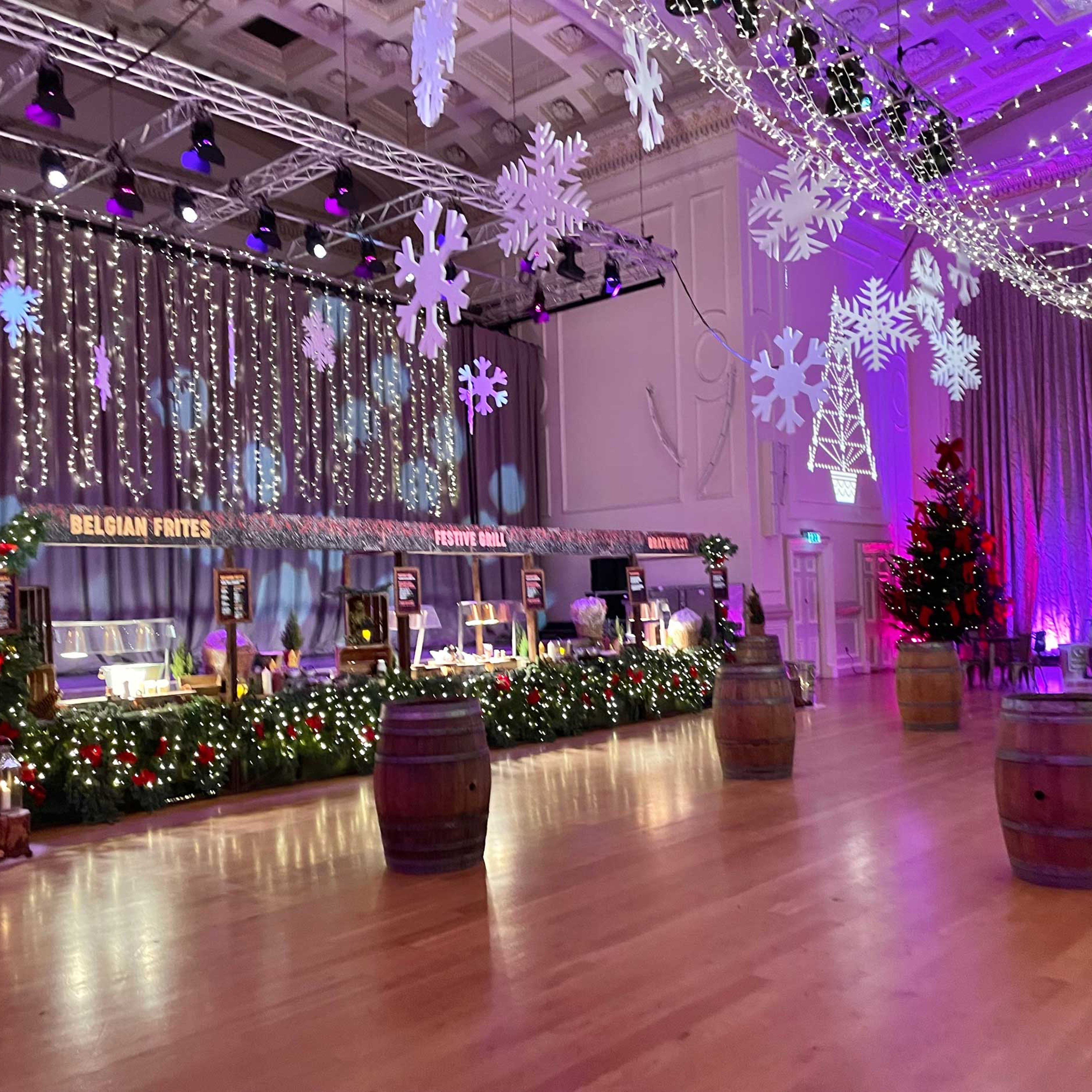 Interior of the Assembly Rooms Edinburgh decorated with food stalls and Christmas lights.