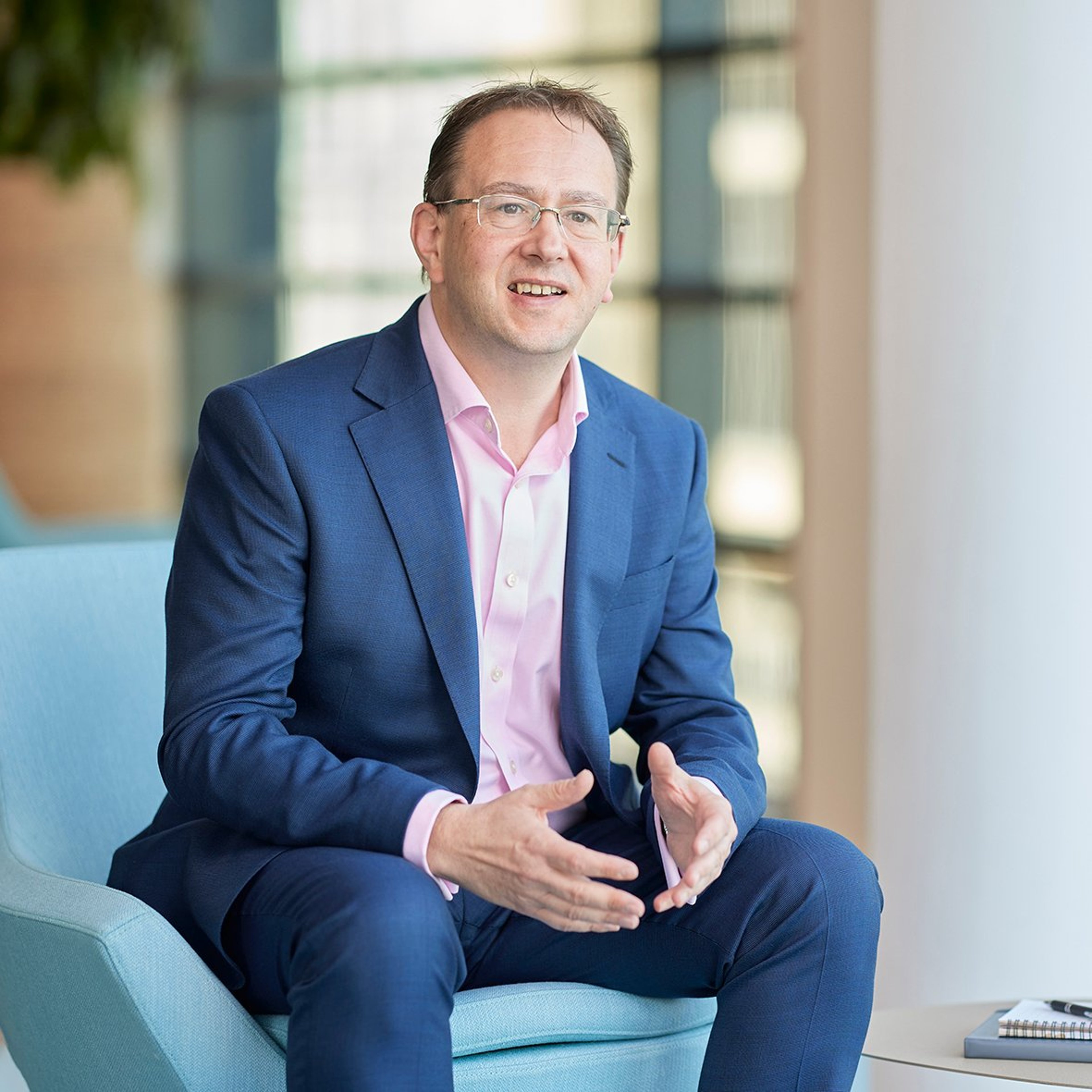 Roger Smillie sittng in the Baillie Gifford office.